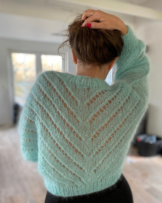 A mohair knit cardigan with diagonal lace pattern as in the 1980's