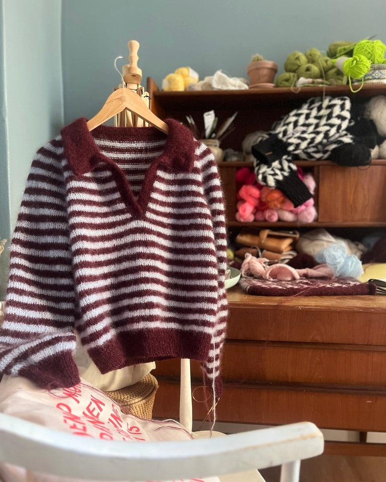 Knitted maroon polo collar sweater detail on hanger