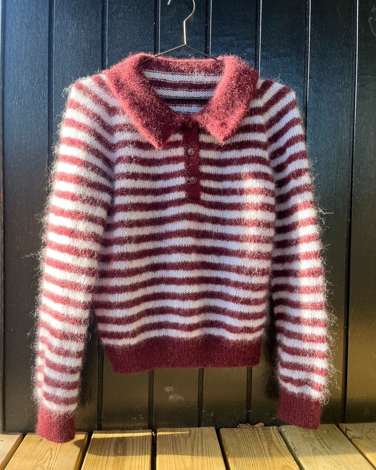 Maroon and white striped knitted polo hanging on hanger